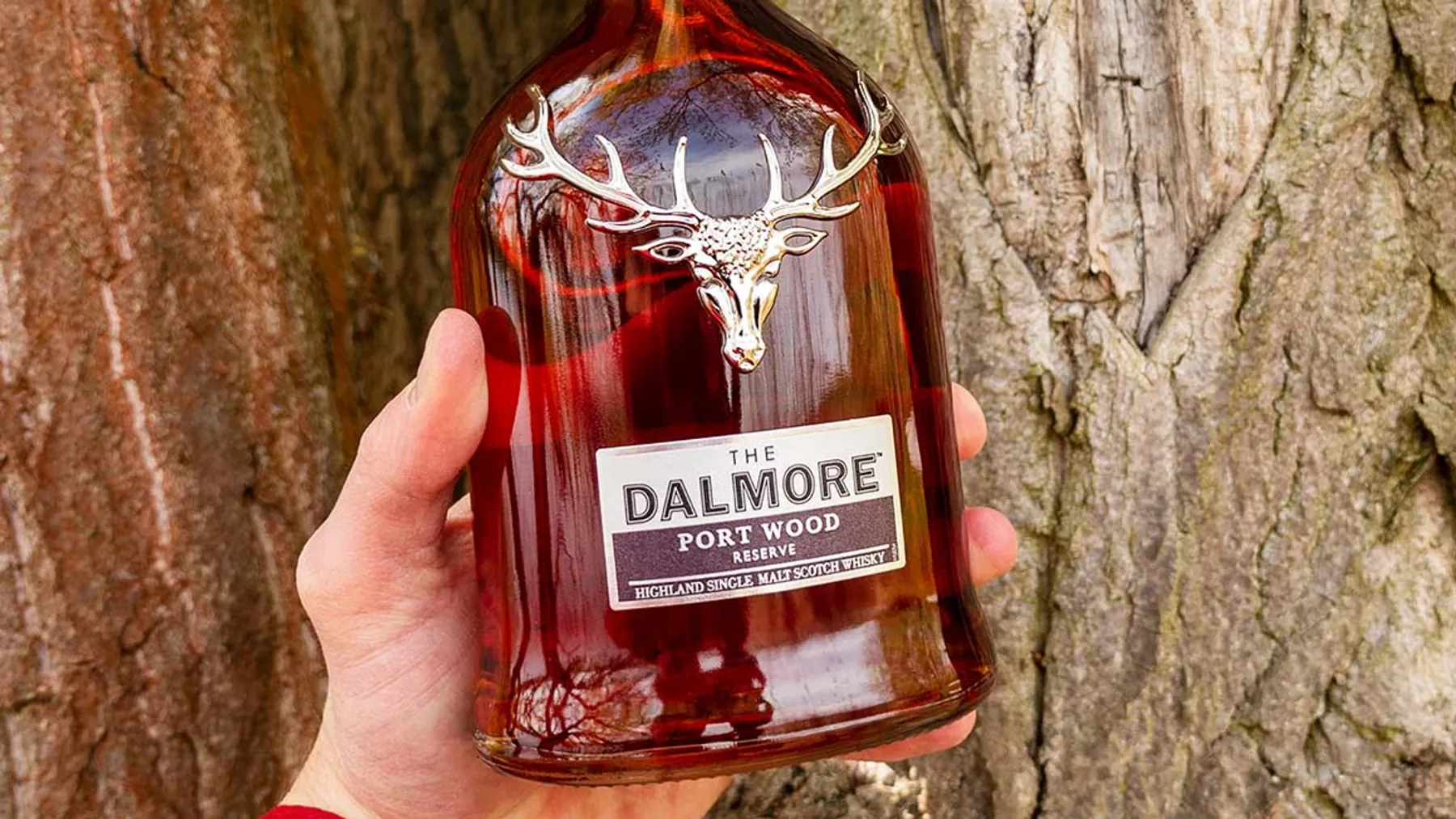 Üzerinde gümüş geyik boynuzu amblemi bulunan şık tasarımlı Dalmore Port Wood Reserve viski şişesi